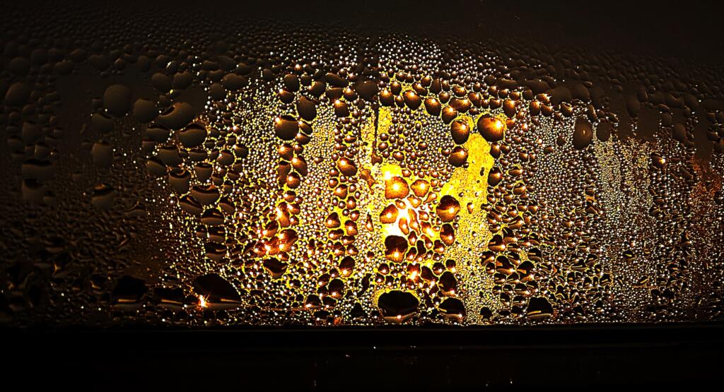 Condensation on a window at sunset